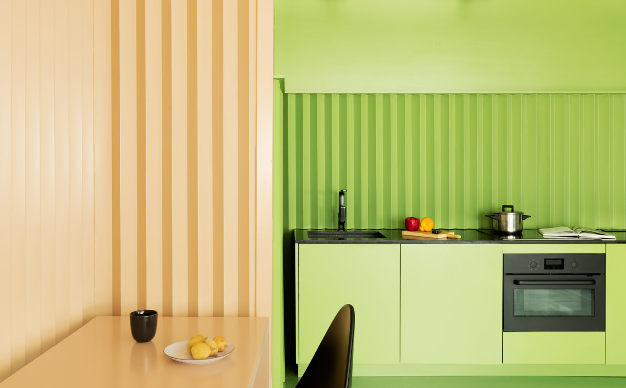 Junto al comedor, encontramos la cocina en color verde.