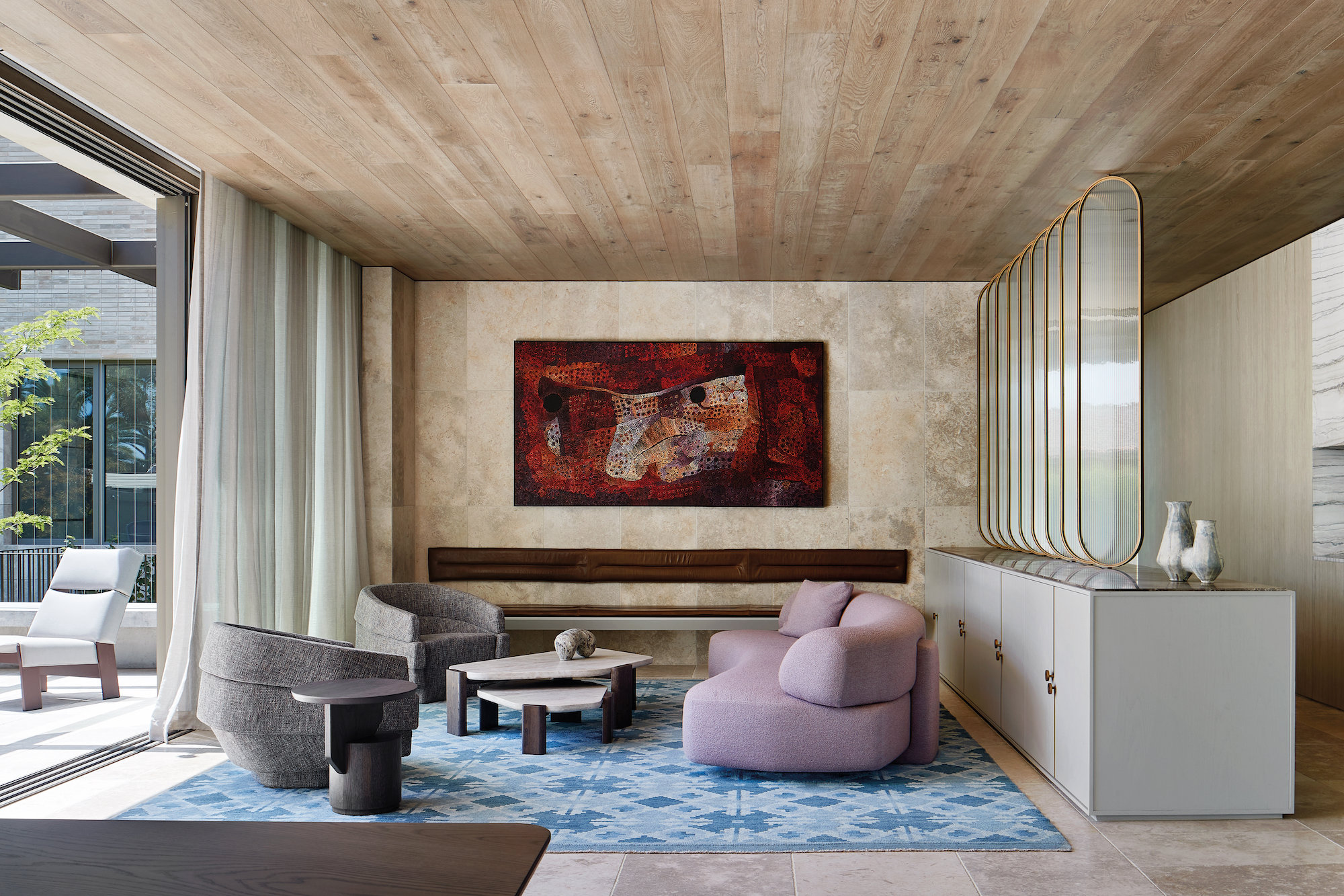 salón con sofá rosa y alfombra en tonos azules