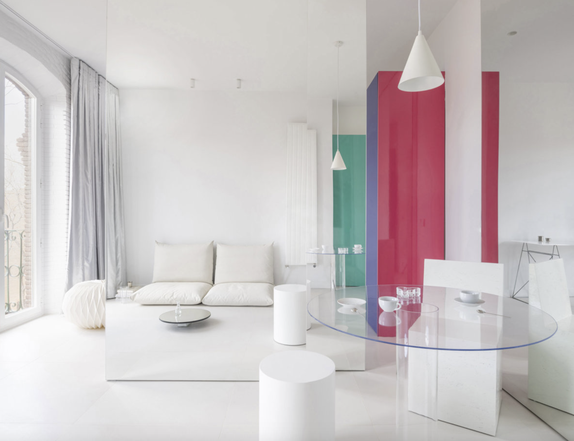 salon blanco con muebles de colores al fondo