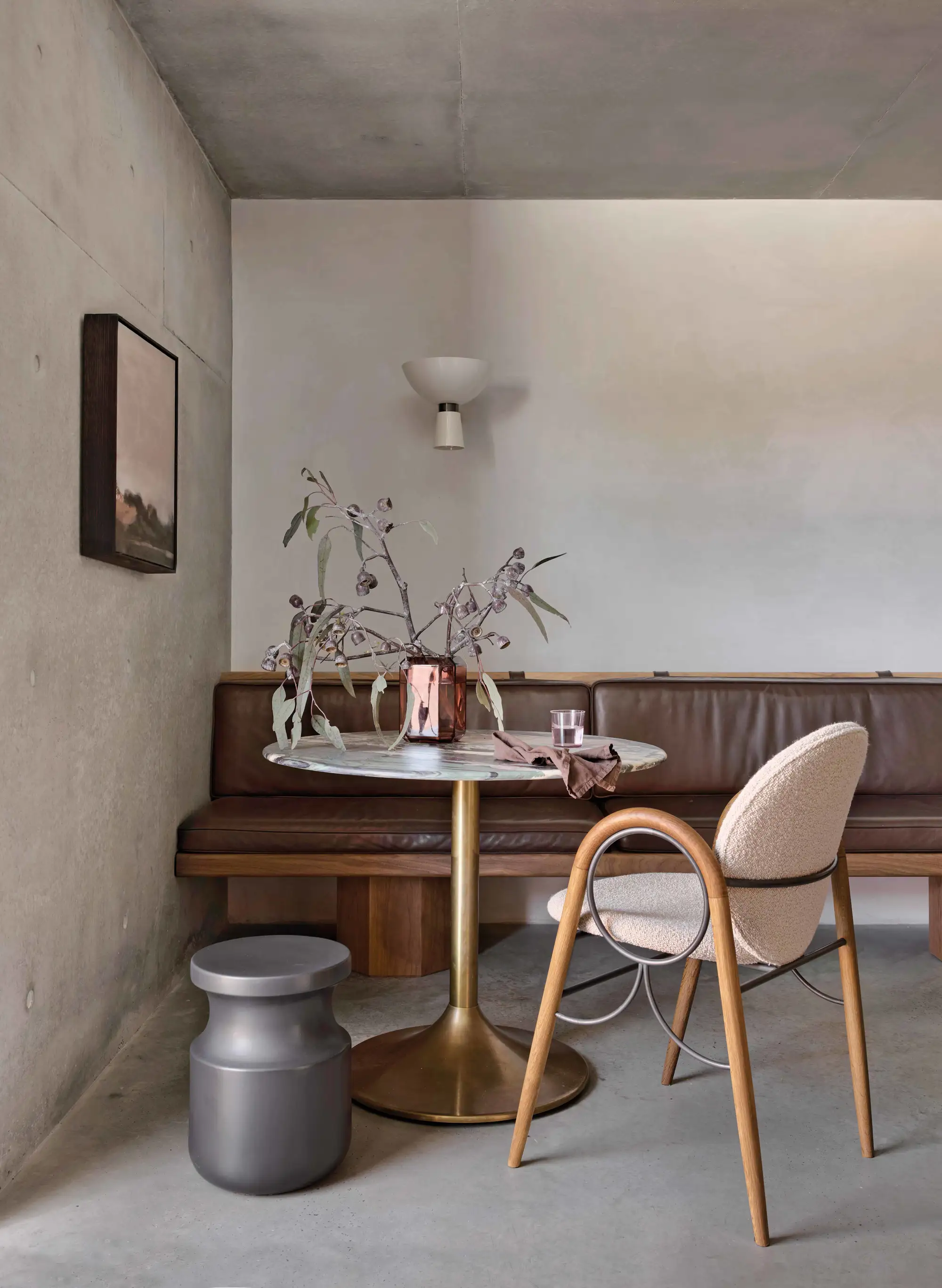 Alexander House Marble table at end of banquette in dining and cafe area