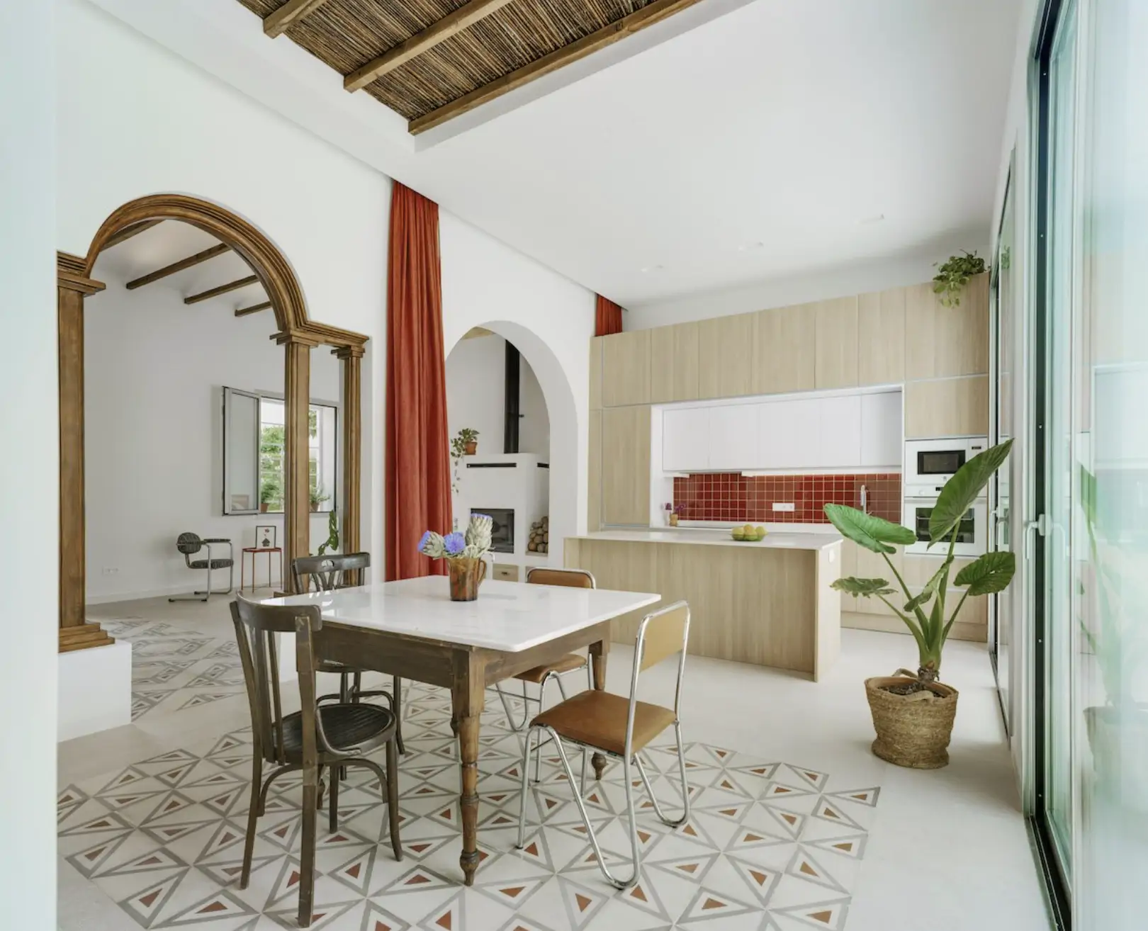 mesa de cocina con techo de madera y una cortina roja