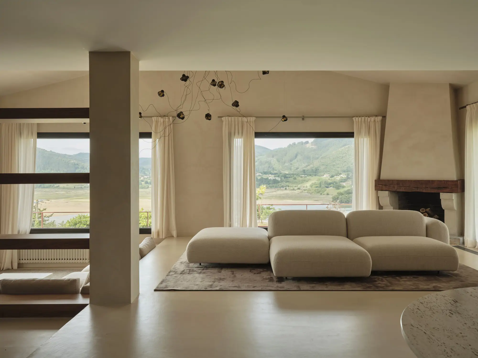 sofas con una chimenea detras y una ventana
